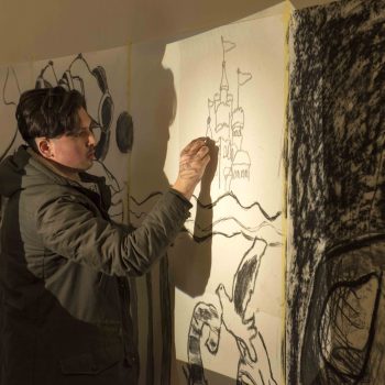 A student intensely concentrating on a piece for our Out of My Roots Student Art projects from Athena Syntax: an education programme that explores questions of identity through art.